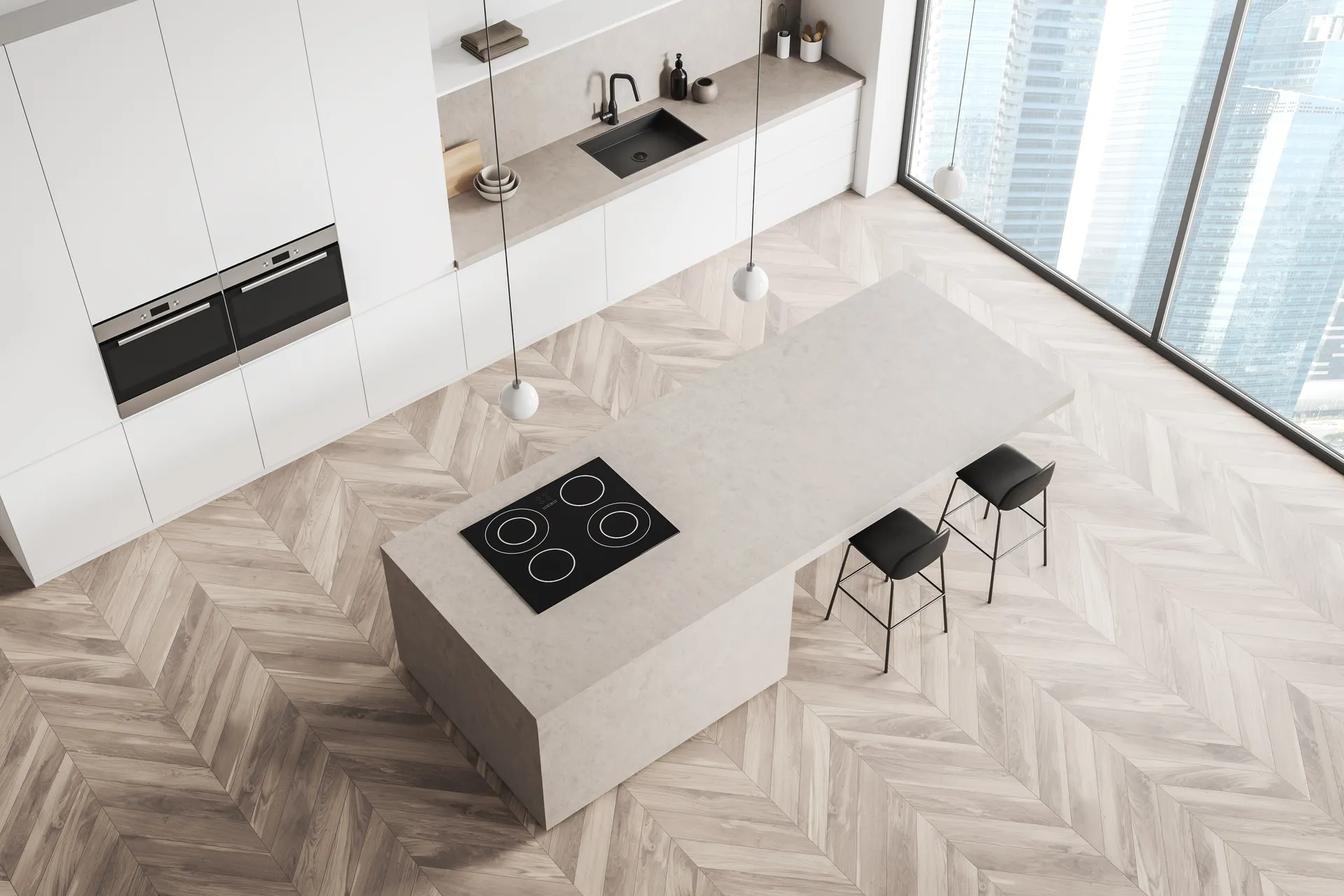 Overhead view of a minimal kitchen with a stone island and herringbone timber flooring