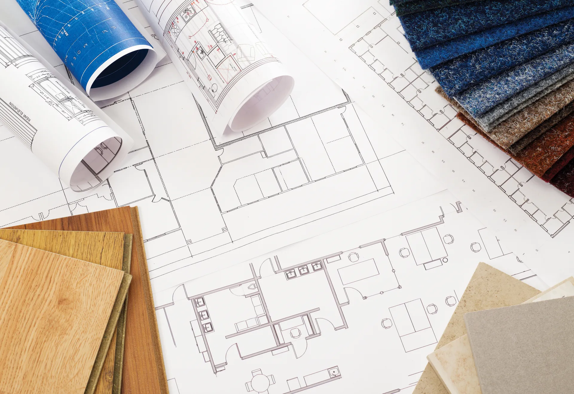Architectural floor plans laid out with timber, stone and textile samples