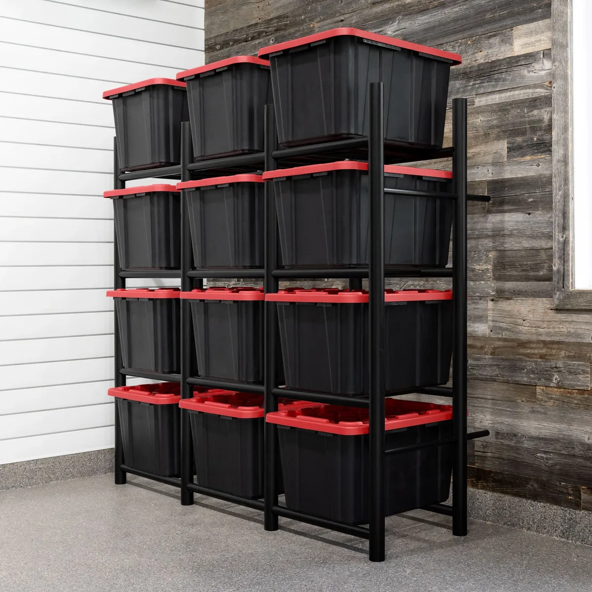 Black storage rack with red-lidded bins arranged against a whitewashed shiplap and reclaimed wood wall